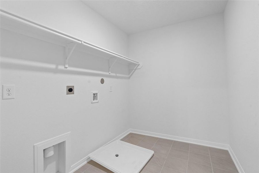 The laundry room conveniently located on the second floor is ready to move in. The open shelf offers quick access to essentials while keeping things airy and bright.