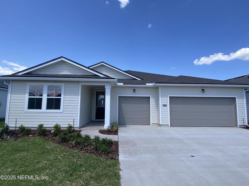 Front exterior of a new home in Lakes at Bella Lago, Green Cove Springs, FL, highlighting curb appeal (Image 13).