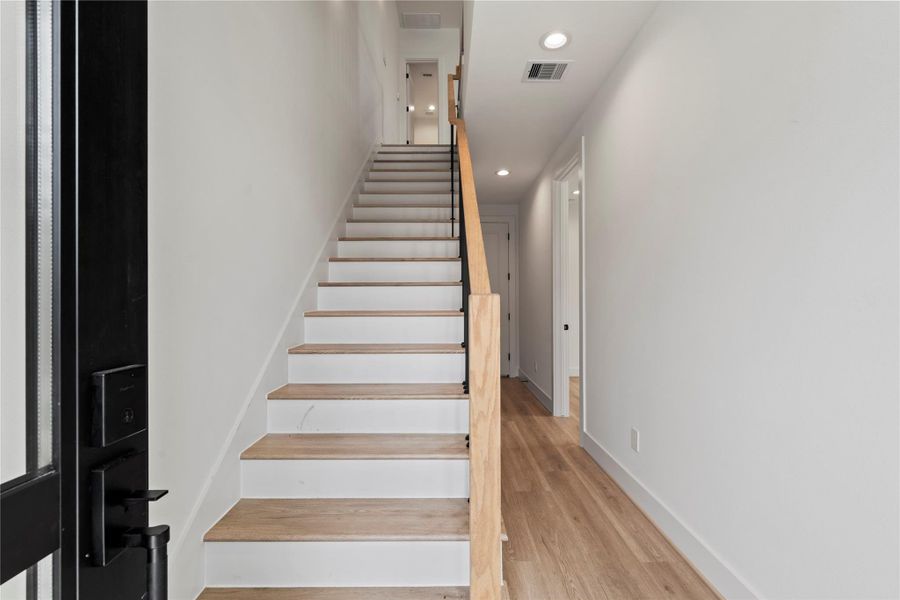 Enter through the stylish tri-paneled glass wooden door to a first floor with two guest bedrooms, one featuring its own ensuite bath. Enter through the stylish tri-paneled glass wooden door to a first floor with two guest bedrooms, one featuring its own ensuite bath.