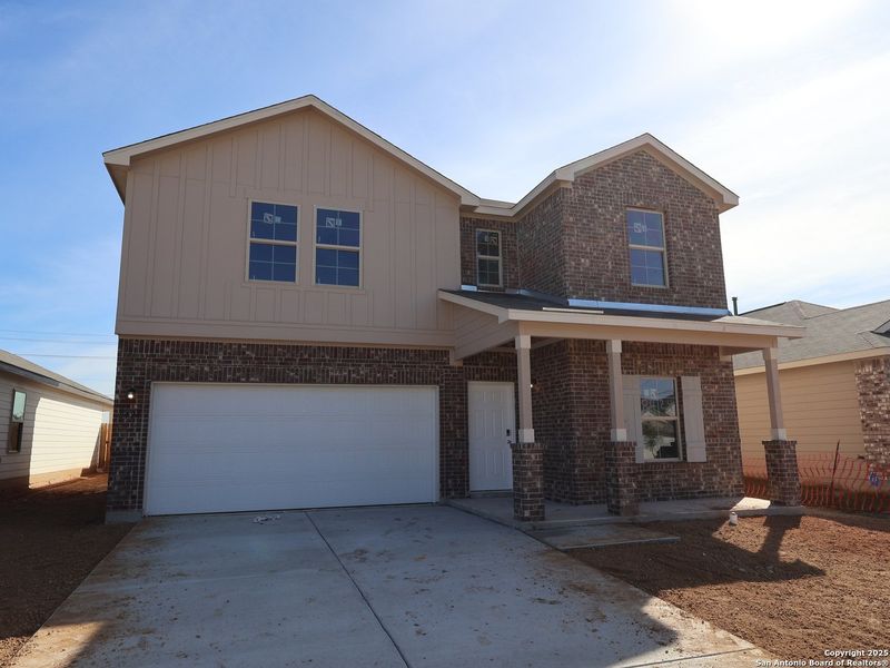 Front exterior of a new home in Agave, San Antonio, TX, highlighting curb appeal (Image 24).
