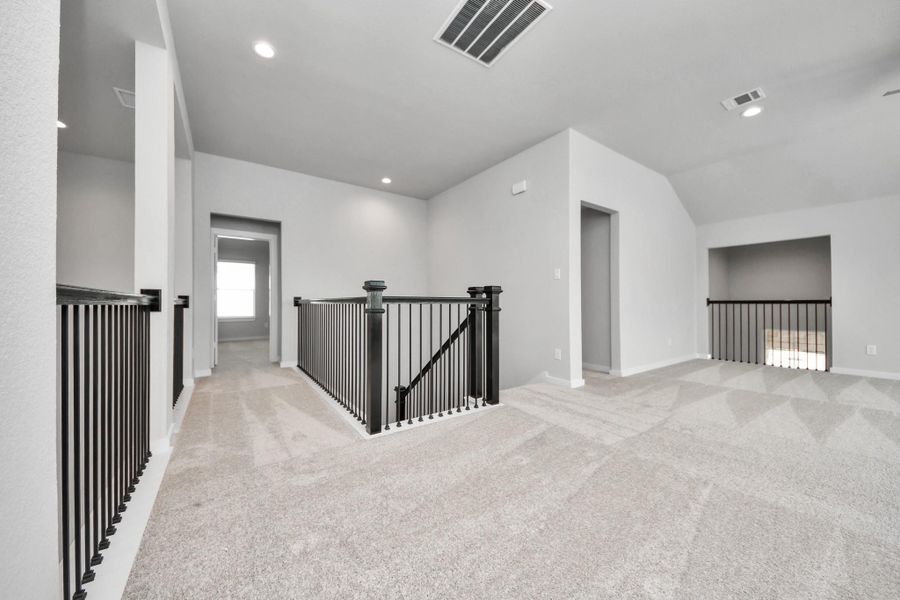 Come upstairs and enjoy a day of leisure in this fabulous game room! This is the perfect hangout spot or adult game room! Features plush carpet, high ceilings, custom paint and windows for plenty of natural light.
