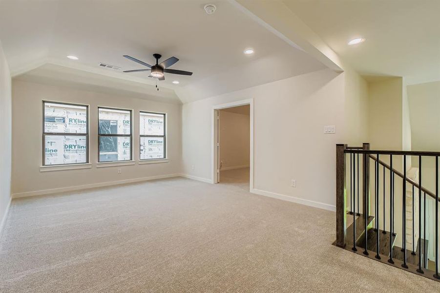 Empty room featuring light colored carpet, a ceiling fan, and recessed lighting