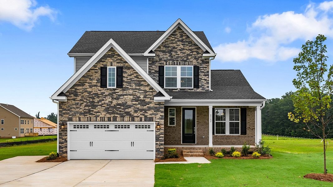 Front exterior of a new home in Lilah Grove, Summerfield, NC, highlighting curb appeal (Image 1).