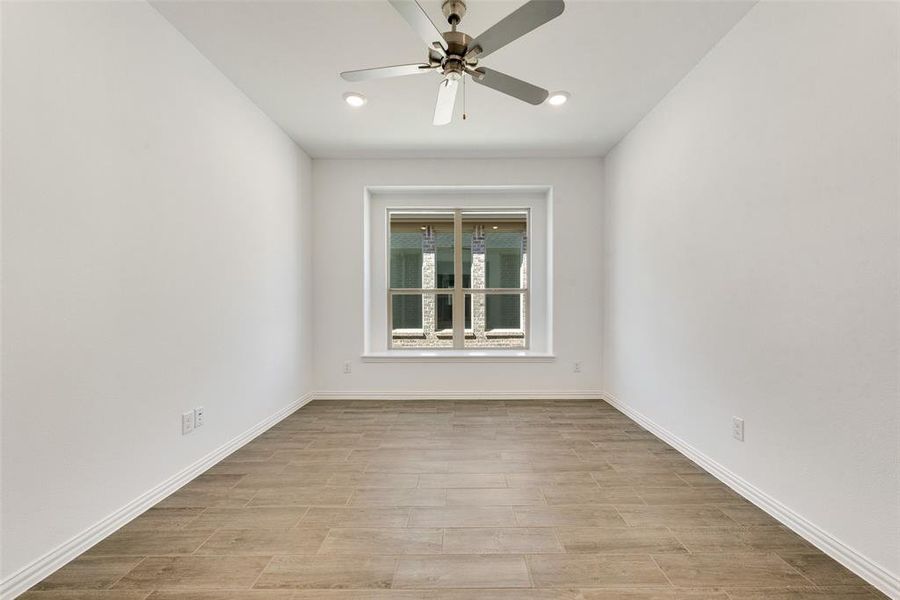 Spare room with light hardwood / wood-style floors and ceiling fan