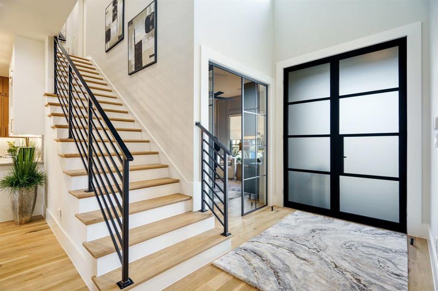 Entrance foyer featuring light hardwood flooring and custom iron doors