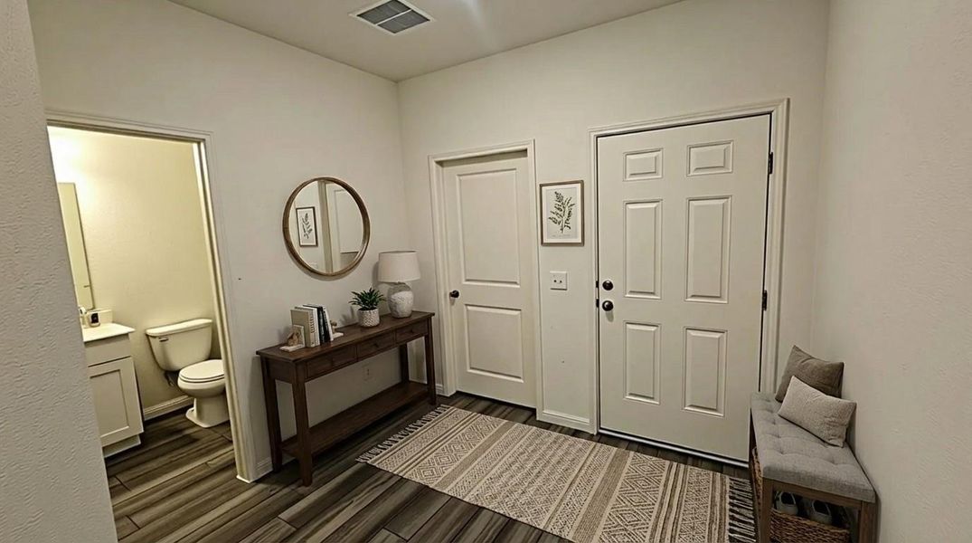 Entryway featuring dark wood-style flooring and baseboards