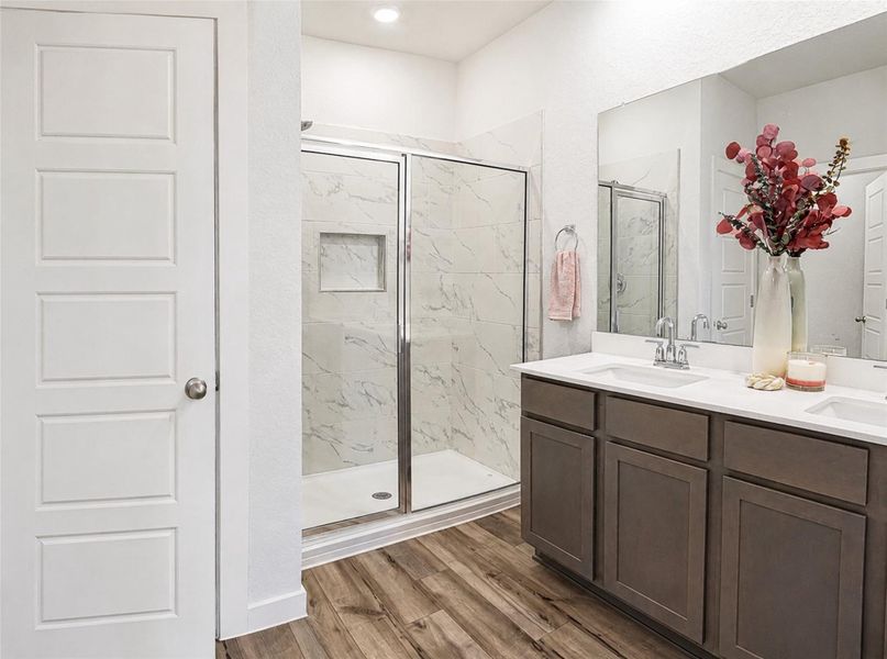 A spacious double vanity anchors this modern bathroom with a tiled walk-in shower. A spacious double vanity anchors this modern bathroom with a tiled walk-in shower.