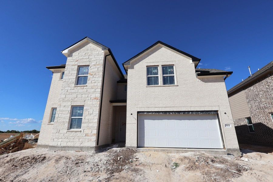 Two story home with 5 beds, 4.5 baths, and 3 car tandem garage.