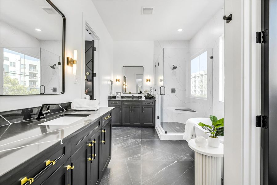 The primary bath was crafted as a sanctuary of relaxation featuring dual vanities with sleek quartz counters, custom cabinetry, and elegant brass-accented hardware. The frameless glass shower showcases floor-to-ceiling porcelain tile with a built-in bench and matte black fixtures, creating a seamless blend of function and sophistication ideal for luxury living near the Texas Medical Center. The primary bath was crafted as a sanctuary of relaxation featuring dual vanities with sleek quartz counters, custom cabinetry, and elegant brass-accented hardware. The frameless glass shower showcases floor-to-ceiling porcelain tile with a built-in bench and matte black fixtures, creating a seamless blend of function and sophistication ideal for luxury living near the Texas Medical Center.
