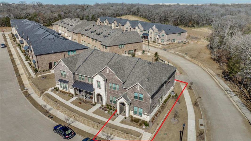 Aerial view with a wooded view and a residential view