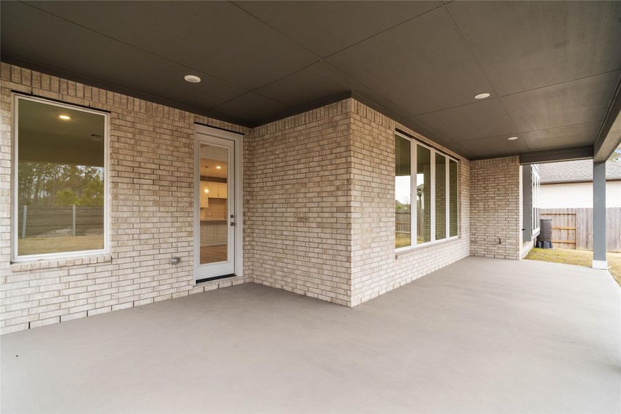 Step outside to the covered rear patio, the perfect extension of your indoor living space for year-round enjoyment.