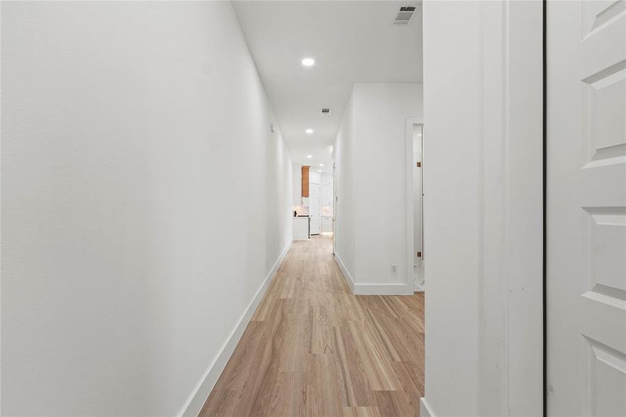 Corridor featuring recessed lighting and light wood-style flooring