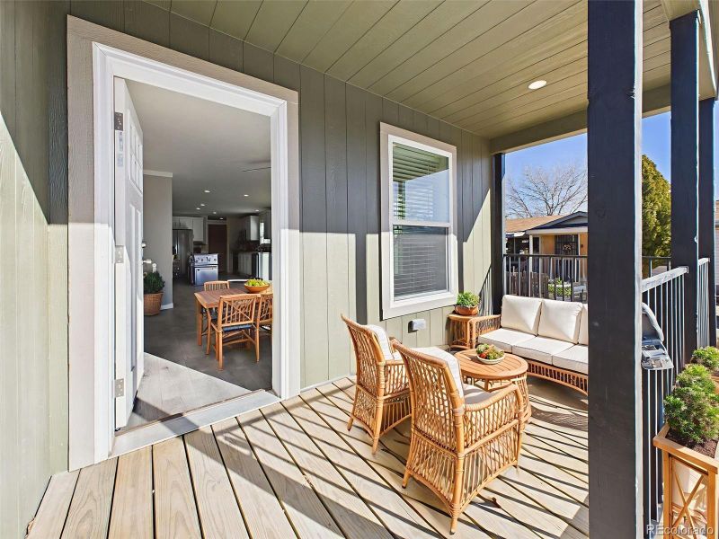 Virtually Staged Front Porch – Imagine peaceful mornings or casual gatherings on this charming covered deck, enhanced with comfortable seating and warm natural light.