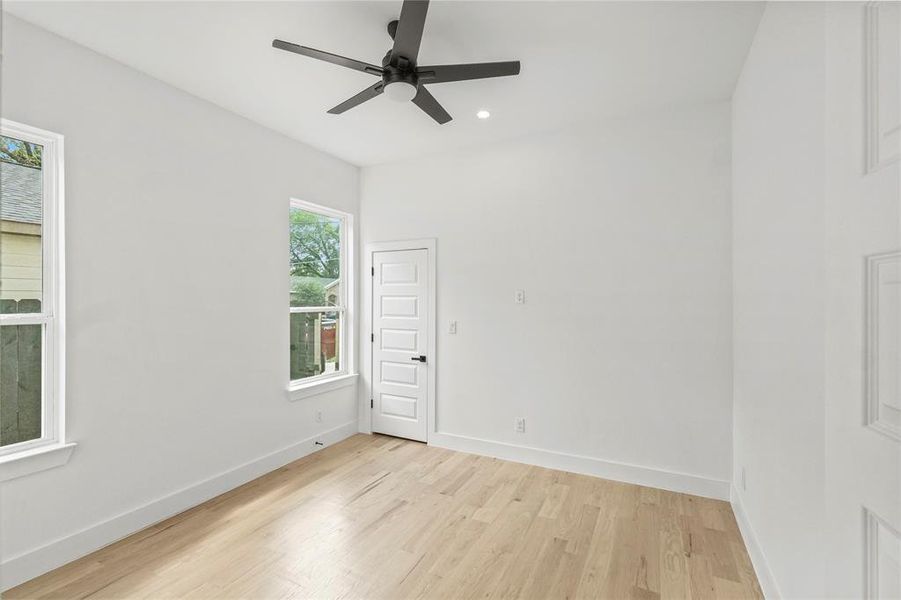 Spare room featuring light wood-type flooring and ceiling fan