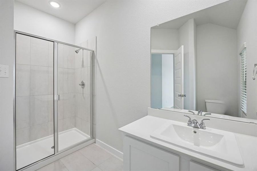 Bathroom in the Masters home plan by Trophy Signature Homes – REPRESENTATIVE PHOTO