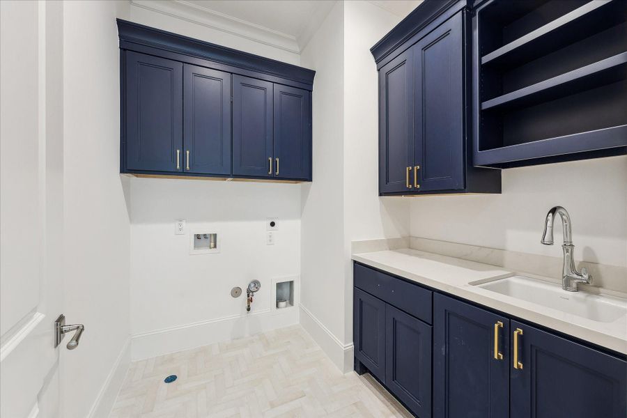 Utility room included on the second floor with plenty of built-in storage, along with Kohler Park Falls enameled cast iron under-mount utility sink and Kohler Simplice compact faucet.