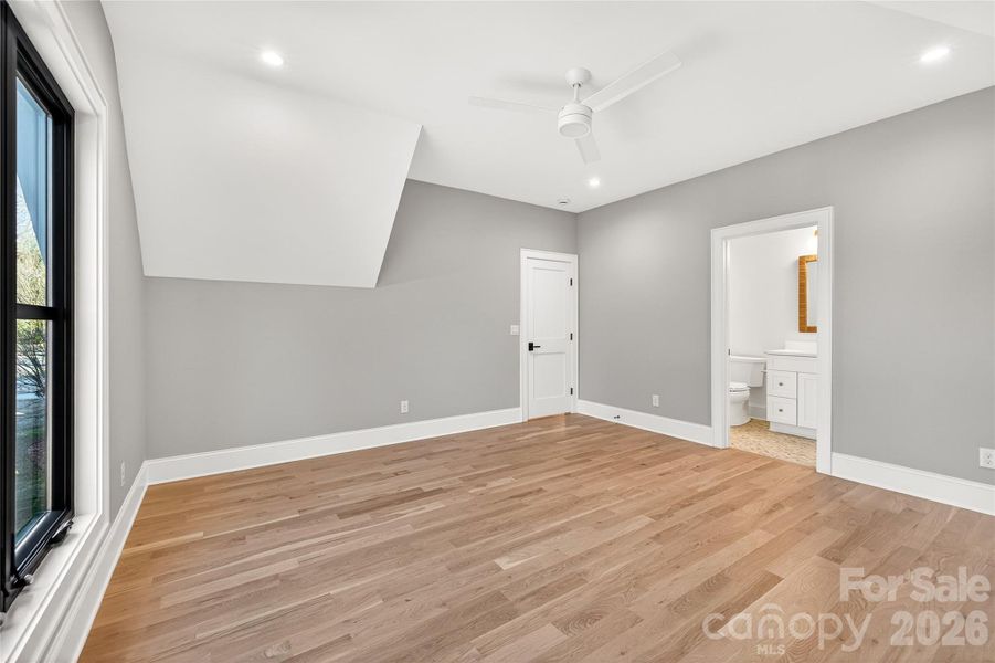 3rd Bedroom on Upper Level. Gray walls, beautiful floors, lighting, In-suite bath, walk-in closet.