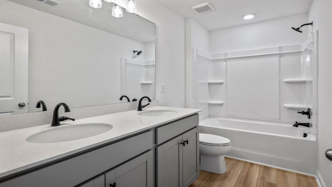 The Pritchard’s secondary bath features a dual vanity and tub