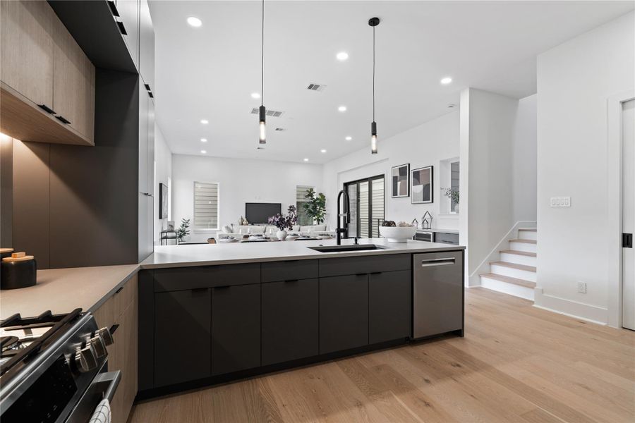 The kitchen’s sculptural restraint is on full display here—an interplay of matte surfaces, clean edges, and integrated functionality. The island stretches wide, ready for everything from prep work to prosecco pours, while the surrounding cabinetry conceals ample storage behind an elegant facade. It’s a space that elevates the ritual of cookinginto something quiet, modern, and beautifully intentional.