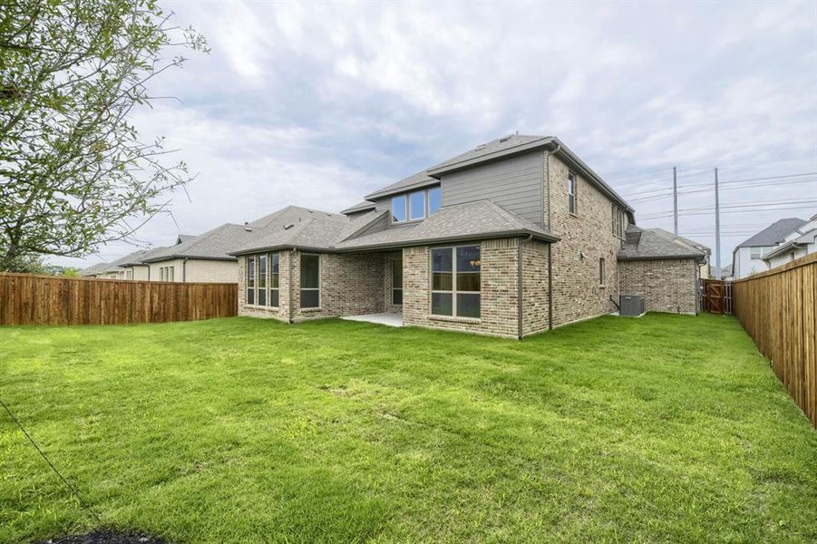 Expansive green lawn with a full wood privacy fence Expansive green lawn with a full wood privacy fence