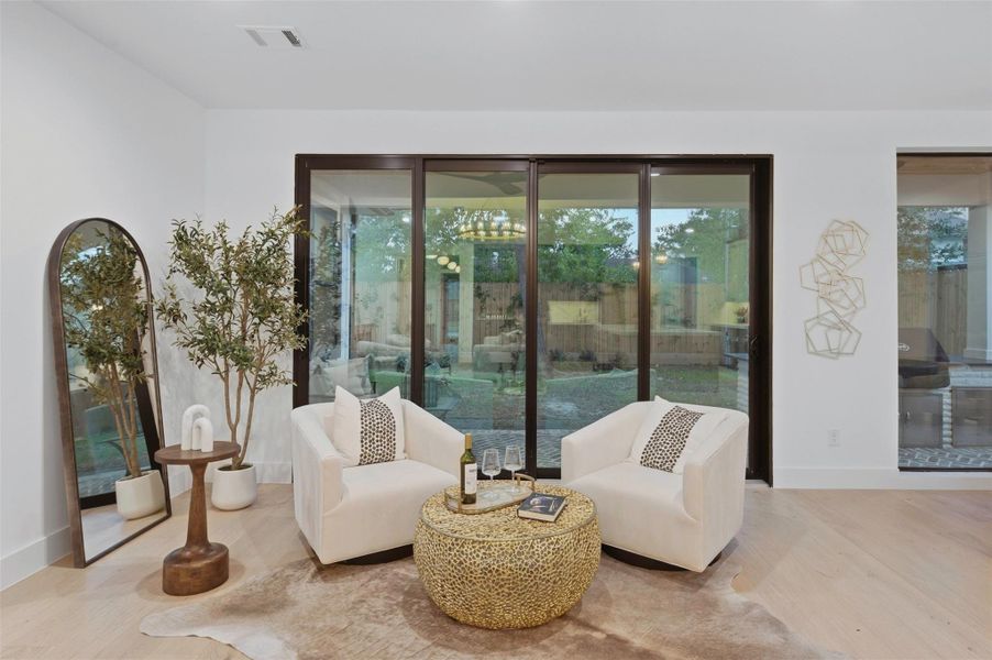 California sliders open from the separate sitting area directly onto the covered patio, creating an effortless indoor-outdoor flow that’s perfect for entertaining.