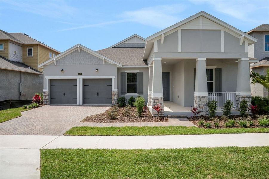 Front exterior of a new home in Avalon Woods, Winter Garden, FL, highlighting curb appeal (Image 2). Front exterior of a new home in Avalon Woods, Winter Garden, FL, highlighting curb appeal (Image 2).