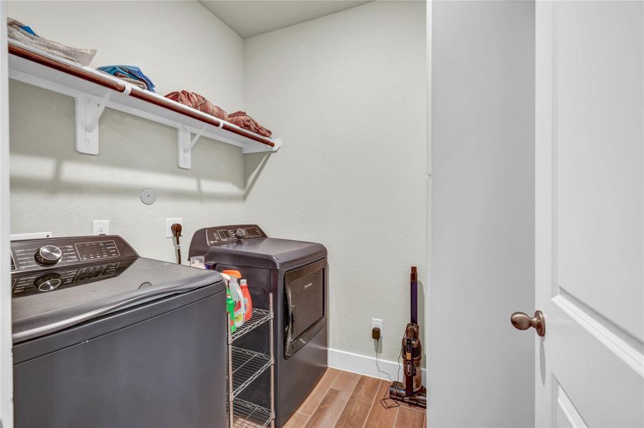 Ample sized laundry room with custom built in cabinetry with shelving Ample sized laundry room with custom built in cabinetry with shelving