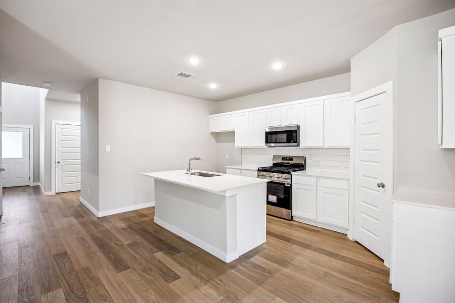Kitchen in the Willow home plan by Trophy Signature Homes – REPRESENTATIVE PHOTO
