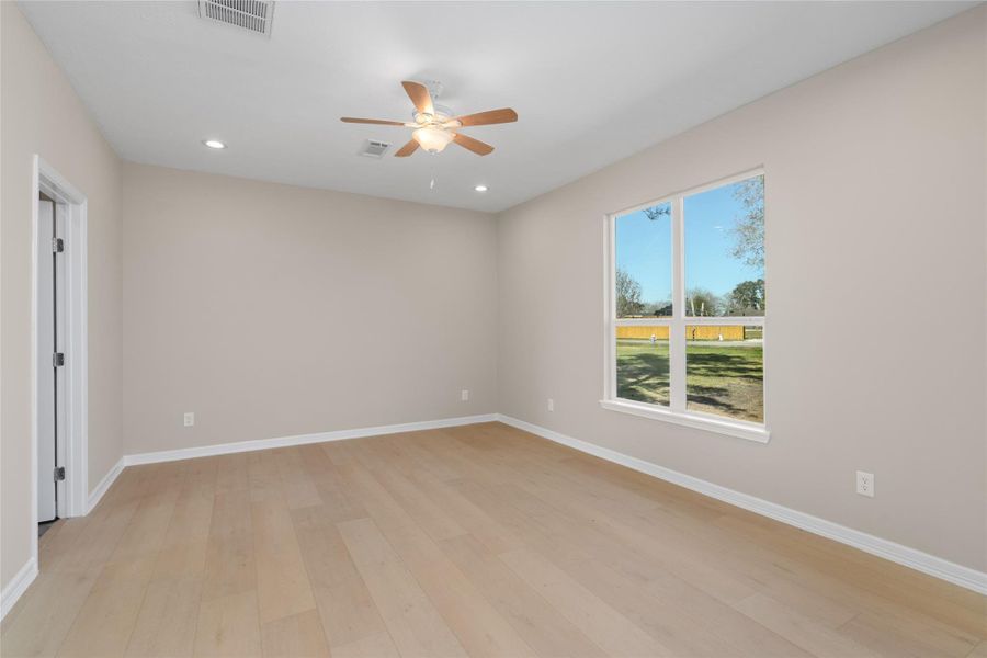 A sun-soaked bedroom withlarge windows invites restfulnights and peacefulmornings, offering bothcomfort and tranquility.