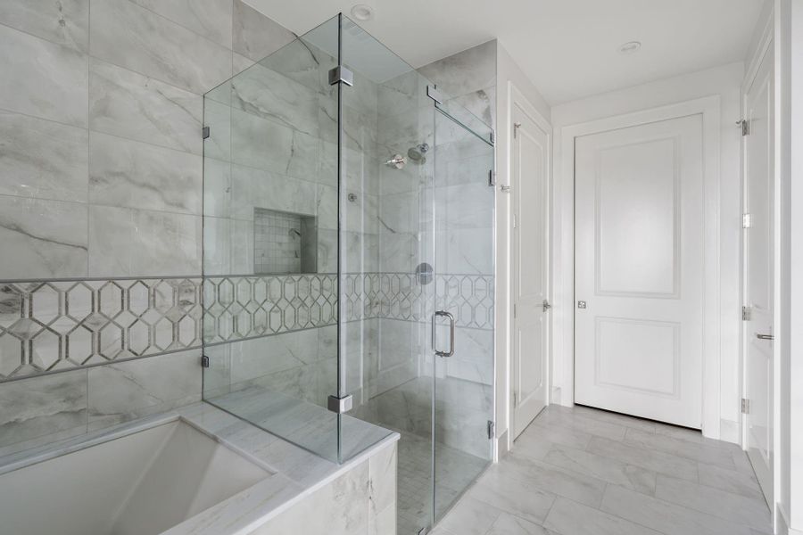 This elegant bathroom features a spacious dual-sink vanity, tile flooring, and a glass-enclosed shower and separate soaking tub. Crystal chandeliers add a touch of luxury, while the large mirror enhances the bright, airy feel. This elegant bathroom features a spacious dual-sink vanity, tile flooring, and a glass-enclosed shower and separate soaking tub. Crystal chandeliers add a touch of luxury, while the large mirror enhances the bright, airy feel.