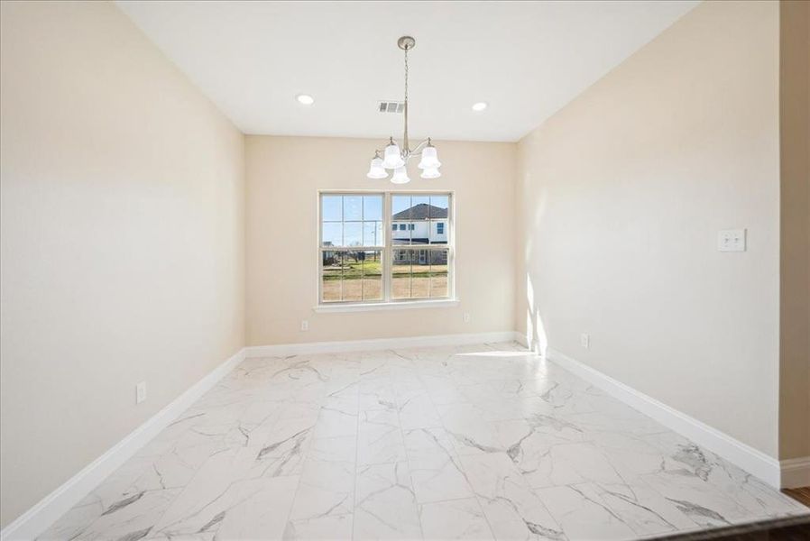 Unfurnished dining area featuring an inviting chandelier