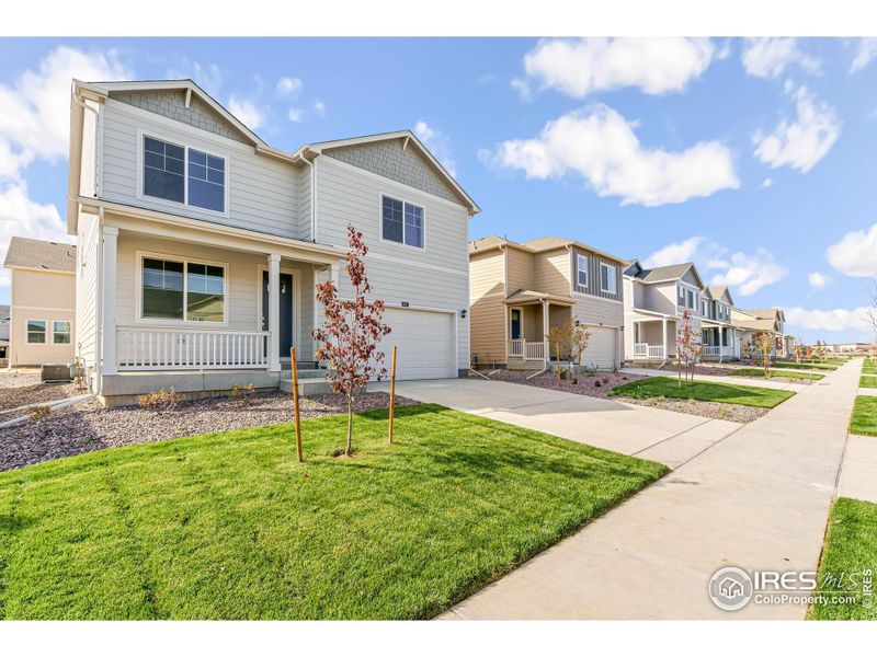 Front exterior of a new home in Silver Peaks, Lochbuie, CO, highlighting curb appeal (Image 15).