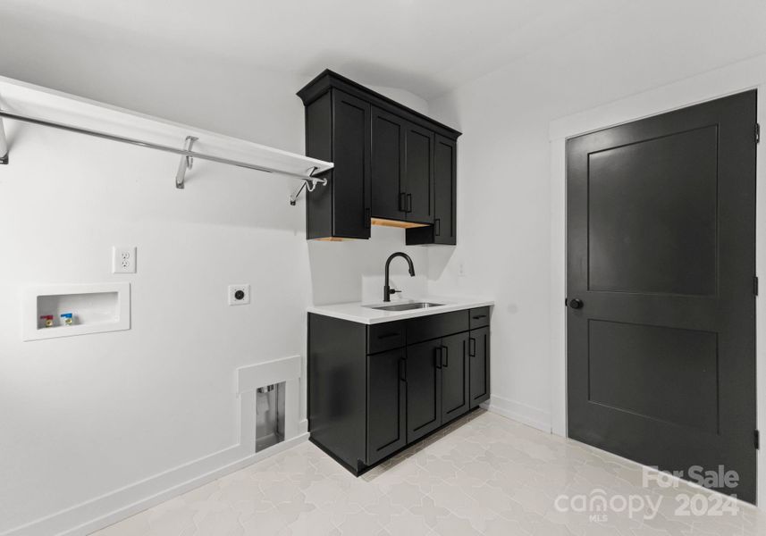 Upstairs laundry room with sink