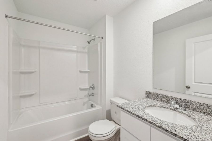 A bathroom with a sink toilet and bathtub.