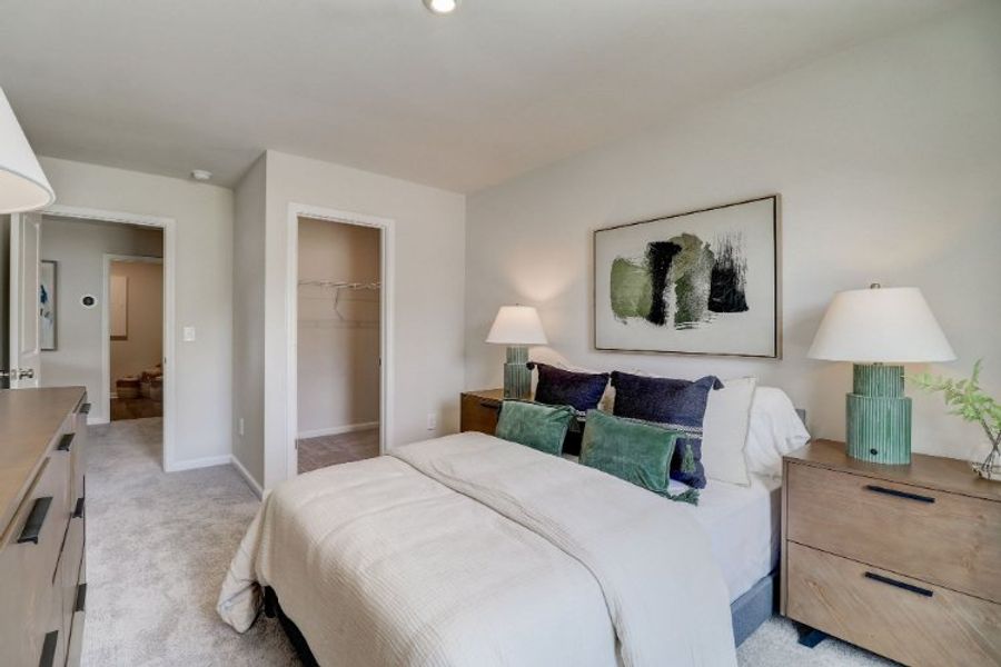 A bedroom with a bed and lamps. A bedroom with a bed and lamps.