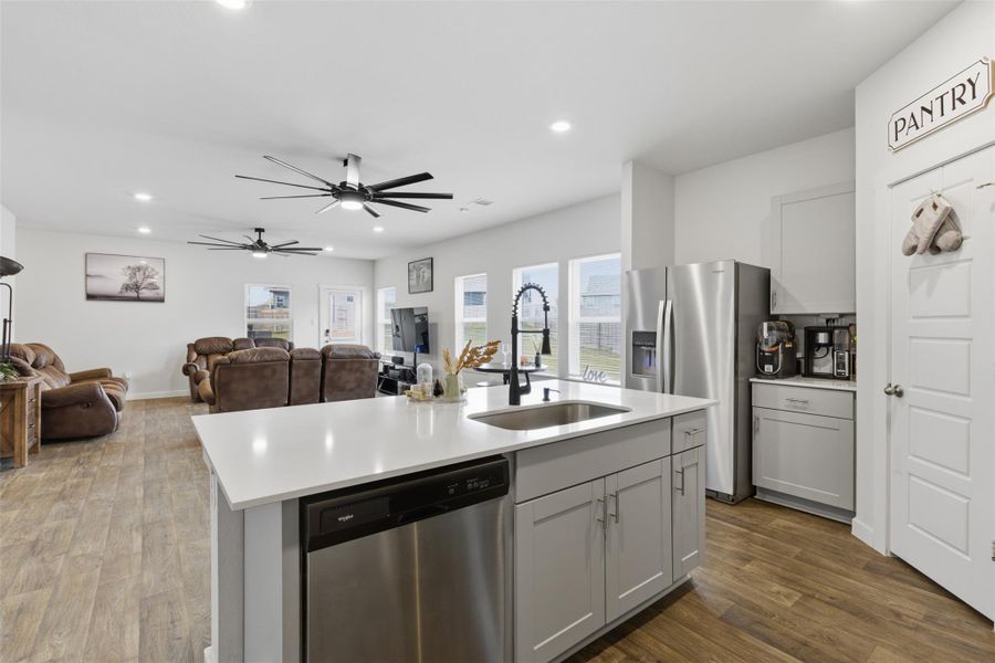 Kitchen featuring appliances with stainless steel finishes, dark wood-style floors, open floor plan, ceiling fan, and recessed lighting