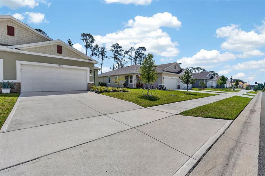 Front exterior of a new home in Halifax Plantation Villas, Ormond Beach, FL, highlighting curb appeal (Image 26).