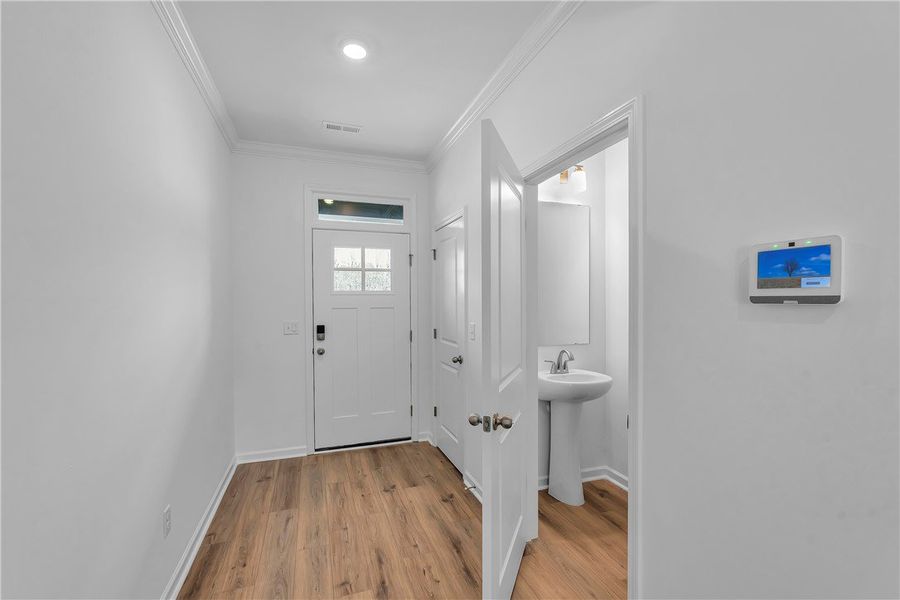 The foyer opens to a convenient half bath, showcas The foyer opens to a convenient half bath, showcas