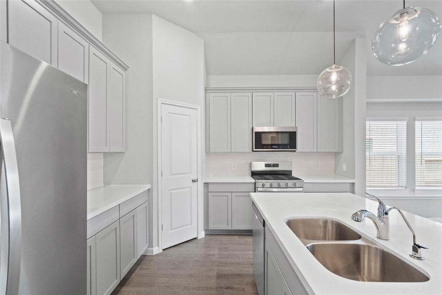 This gorgeous kitchen is an entertainer’s dream, featuring an oversized island, premium finishes, and abundant storage. Designed as the home's ultimate social hub, it offers the perfect balance of open-concept beauty and functional workspace.