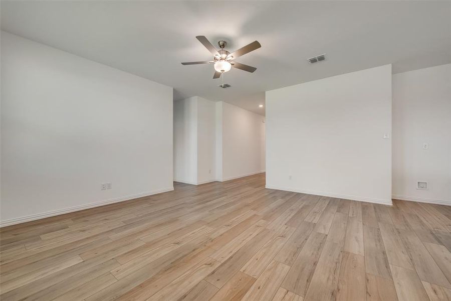 Unfurnished room with ceiling fan and light hardwood / wood-style floors