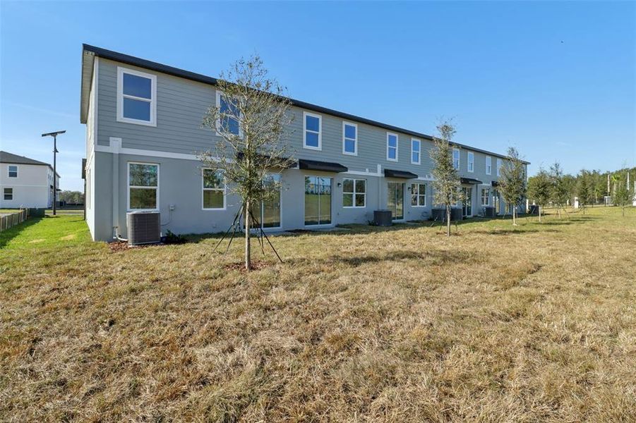 Exterior details and patio area of a home in The Reserve at Hammock Oaks Townes, Lady Lake (Image 21).