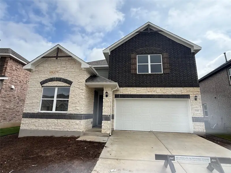 Front exterior of a new home in Berry Creek Highlands, Georgetown, TX, highlighting curb appeal (Image 2). Front exterior of a new home in Berry Creek Highlands, Georgetown, TX, highlighting curb appeal (Image 2).