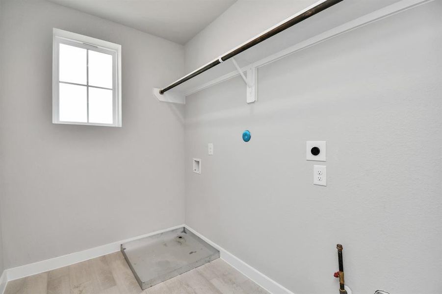 Stylish laundry room where practicality meets a contemporary aesthetic. The dark finishes lend a sophisticated touch, creating a space that is both functional and visually appealing. Both electric and gas connections available.