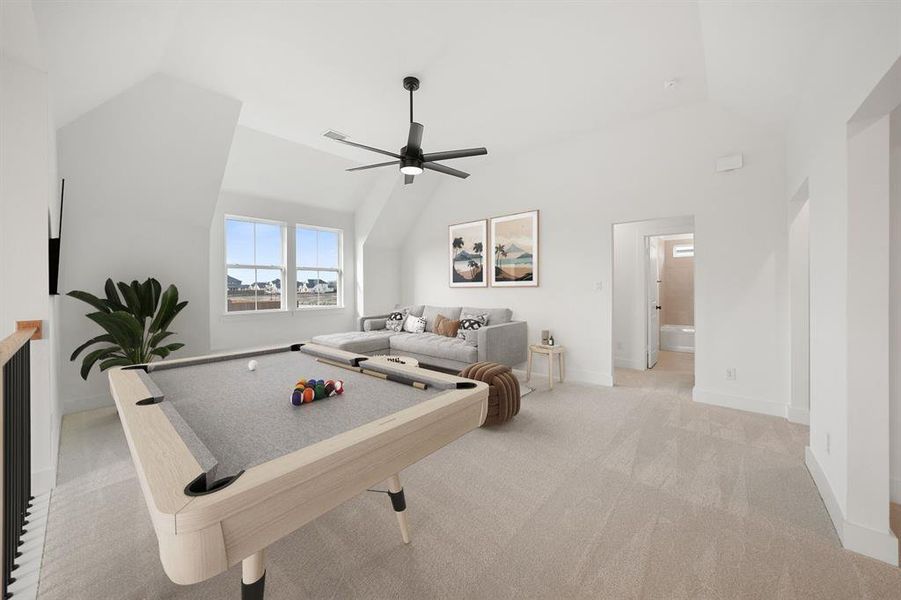 Game room with vaulted ceiling, billiards table, light colored carpet, and a ceiling fan