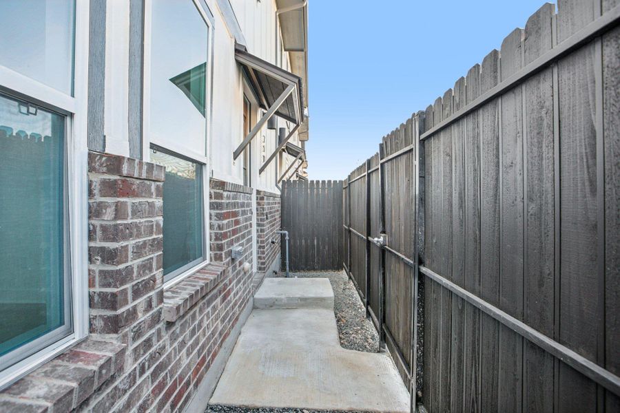 Exterior details and patio area of a home in Koenig Townhomes, Austin (Image 24).