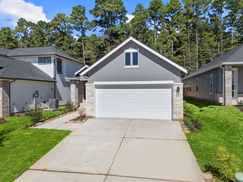 Front exterior of a new home in Westridge Cove, Conroe, TX, highlighting curb appeal (Image 2).