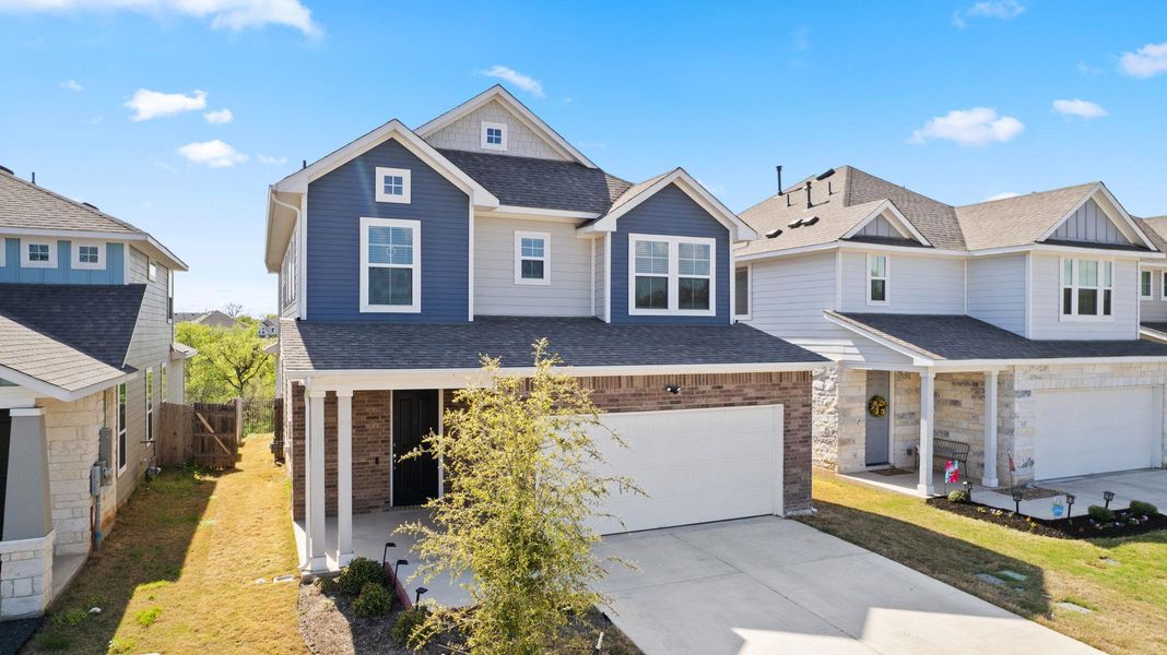 View of front facade with a front yard, concrete driveway, a shingled roof, and an attached garage View of front facade with a front yard, concrete driveway, a shingled roof, and an attached garage