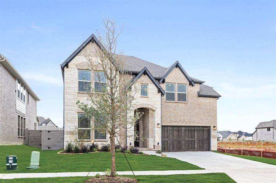 Front exterior of a new home in Painted Tree Woodland District 50, McKinney, TX, highlighting curb appeal (Image 2). Front exterior of a new home in Painted Tree Woodland District 50, McKinney, TX, highlighting curb appeal (Image 2).