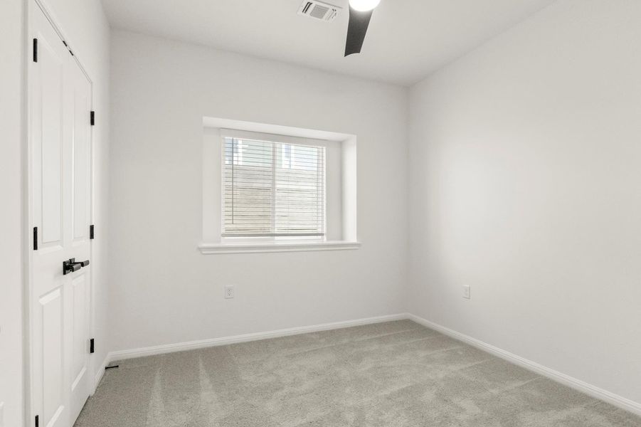 Unfurnished bedroom with light carpet, ceiling fan, and a closet