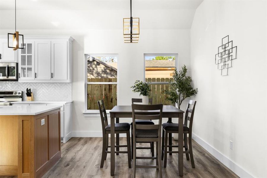 Dining space with dark hardwood / wood-style floors